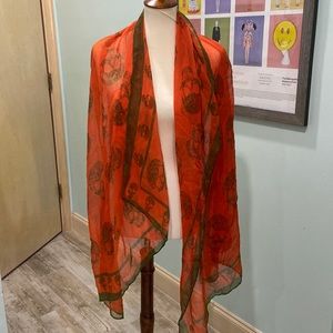 Orange long scarf with olive green skulls. 36 inches by 72 inches